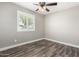 Bedroom featuring wood-look floors, a ceiling fan, and window shutters at 2302 E Monte Cristo Ave, Phoenix, AZ 85022