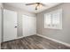 Bedroom featuring wood-look floors, a closet, and a window at 2302 E Monte Cristo Ave, Phoenix, AZ 85022