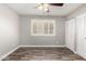 Bedroom featuring wood-look floors, a ceiling fan, a window, and closet doors at 2302 E Monte Cristo Ave, Phoenix, AZ 85022