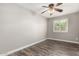 Bedroom featuring wood-look floors, a ceiling fan, and window shutters at 2302 E Monte Cristo Ave, Phoenix, AZ 85022