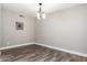 Neutral dining room featuring wood-look floors and a modern chandelier at 2302 E Monte Cristo Ave, Phoenix, AZ 85022
