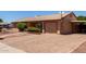 Exterior home view showing brick driveway, desert landscaping and attached garage at 2302 E Monte Cristo Ave, Phoenix, AZ 85022