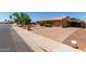 Charming single-story home with a brick driveway, low maintenance landscaping, and covered parking at 2302 E Monte Cristo Ave, Phoenix, AZ 85022