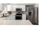Well-lit kitchen featuring stainless steel appliances and white cabinets at 2302 E Monte Cristo Ave, Phoenix, AZ 85022