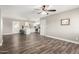 Spacious living room featuring laminate floors and white kitchen view at 2302 E Monte Cristo Ave, Phoenix, AZ 85022