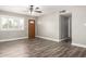 Neutral living room featuring wood-look floors, a ceiling fan, and window shutters at 2302 E Monte Cristo Ave, Phoenix, AZ 85022