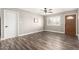 Open living room featuring a ceiling fan, laminate floors and a front entry door at 2302 E Monte Cristo Ave, Phoenix, AZ 85022