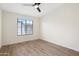 A bedroom with hard surface floors and a window with horizontal blinds is brightened by a ceiling fan with integrated lighting at 2401 E Rio Salado Pkwy # 1055, Tempe, AZ 85288