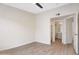 A bedroom featuring neutral paint, ceiling fan, hard surface floors, and a glimpse into the ensuite bathroom at 2401 E Rio Salado Pkwy # 1055, Tempe, AZ 85288