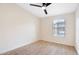 Bedroom with plank flooring, ceiling fan, and window with neighborhood view at 2401 E Rio Salado Pkwy # 1055, Tempe, AZ 85288