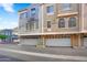 A view of a multi-tone townhouse featuring a garage and address numbers at 2401 E Rio Salado Pkwy # 1055, Tempe, AZ 85288