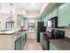 The kitchen offers green cabinets, stainless steel appliances, and ample counter space at 2401 E Rio Salado Pkwy # 1055, Tempe, AZ 85288
