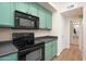 This kitchen has black appliances, wood-style floors, and bright green cabinets at 2401 E Rio Salado Pkwy # 1055, Tempe, AZ 85288