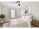 Staged main bedroom features a coordinated aesthetic, carpet, curtains, and a ceiling fan with an integrated light at 2401 E Rio Salado Pkwy # 1055, Tempe, AZ 85288