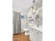 Clean and bright bathroom with white cabinets, shower-tub combo, and modern lighting fixtures at 2715 E Edgemont Ave, Phoenix, AZ 85008