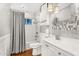 Bright bathroom featuring a shower-tub combo, updated vanity, and decorative mirror at 2715 E Edgemont Ave, Phoenix, AZ 85008
