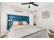 Cozy bedroom with a full-sized bed featuring built in headboard and modern ceiling fan at 2715 E Edgemont Ave, Phoenix, AZ 85008