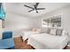 Bright bedroom showcasing two beds, hardwood floors, ceiling fan, and nice natural light at 2715 E Edgemont Ave, Phoenix, AZ 85008