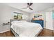 Spacious bedroom with gray bed frame, blue dresser, and natural light from two windows at 2715 E Edgemont Ave, Phoenix, AZ 85008