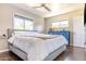 Bedroom with two large windows, hardwood floors, and a comfortable bed at 2715 E Edgemont Ave, Phoenix, AZ 85008