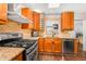 Modern kitchen with granite counters, stainless steel appliances, wine rack, and backsplash at 2715 E Edgemont Ave, Phoenix, AZ 85008