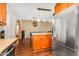 Open kitchen with stainless steel refrigerator, wood cabinets, and granite island at 2715 E Edgemont Ave, Phoenix, AZ 85008