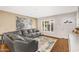 Comfortable living room boasts a large gray sectional sofa, front door access, and large art piece at 2715 E Edgemont Ave, Phoenix, AZ 85008