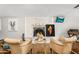 Bright living room featuring brick fireplace and two comfy chairs and TV above at 2715 E Edgemont Ave, Phoenix, AZ 85008