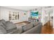 Cozy living room features a large gray sofa, front door access, and entertainment center at 2715 E Edgemont Ave, Phoenix, AZ 85008