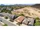 Single-story home has desert landscaping, tile roof, and two-car garage. View of the backyard pool, surrounded by desert terrain at 3028 W Parkside Ln, Phoenix, AZ 85027