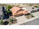 Single-level home with desert landscaping, tile roof, and an attached two-car garage is viewed from above at 3028 W Parkside Ln, Phoenix, AZ 85027