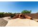 Backyard features fireplace with seating area and decorative rocks at 3028 W Parkside Ln, Phoenix, AZ 85027