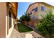 Side yard with artificial turf, stone border, and decorative rock at 3028 W Parkside Ln, Phoenix, AZ 85027
