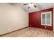 Bedroom with wood-look floors, a red accent wall, and a ceiling fan at 3028 W Parkside Ln, Phoenix, AZ 85027