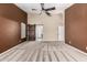 Bedroom with neutral carpeting, vaulted ceiling, barn door access to bathroom, and plantation shutters at 3028 W Parkside Ln, Phoenix, AZ 85027