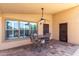 Covered patio with tiled floor, ceiling fan, bar-height table and seating, and window at 3028 W Parkside Ln, Phoenix, AZ 85027