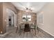 Dining room featuring a stone accent wall, modern table and chairs, and neutral decor at 3028 W Parkside Ln, Phoenix, AZ 85027