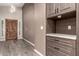 Stylish entryway featuring wood floors, a dark wood door, and built-in cabinets at 3028 W Parkside Ln, Phoenix, AZ 85027