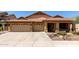 Charming single-story home with a three-car garage, desert landscaping, and a tile roof at 3028 W Parkside Ln, Phoenix, AZ 85027