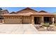 Charming single-story home with a three-car garage, desert landscaping, and a tile roof at 3028 W Parkside Ln, Phoenix, AZ 85027