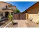 Paver walkway leading to a wood gate with desert landscaping in this stylish home at 3028 W Parkside Ln, Phoenix, AZ 85027