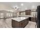 Bright kitchen with a large center island, wood cabinets, and views into the living area at 3028 W Parkside Ln, Phoenix, AZ 85027
