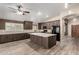 Modern kitchen with dark wood cabinets, white countertops, and sleek black appliances at 3028 W Parkside Ln, Phoenix, AZ 85027