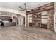 Open-concept living room with tile floors, stone accents, and seamless flow to kitchen at 3028 W Parkside Ln, Phoenix, AZ 85027