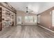 Bright living room featuring wood accent wall and tile floors at 3028 W Parkside Ln, Phoenix, AZ 85027