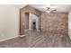 Living room with stone accent wall, tile floors, and open archway to other spaces at 3028 W Parkside Ln, Phoenix, AZ 85027