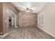 Spacious living room with tile floors, stone accent wall, and natural light at 3028 W Parkside Ln, Phoenix, AZ 85027