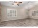 Inviting living space with wood-look tile flooring, neutral paint, and plantation shutters at 3028 W Parkside Ln, Phoenix, AZ 85027
