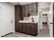 Mud room with utility sink, overhead and base cabinets and view to interior living area at 3028 W Parkside Ln, Phoenix, AZ 85027