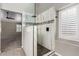 Modern glass walk-in shower with decorative tile and updated fixtures at 3028 W Parkside Ln, Phoenix, AZ 85027